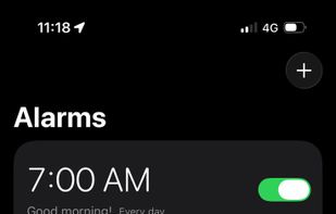 The alarm list, in the dark interface the app uses throughout.