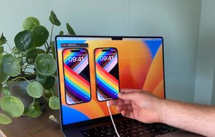 A photo of iPhone connected to the MacBook Pro