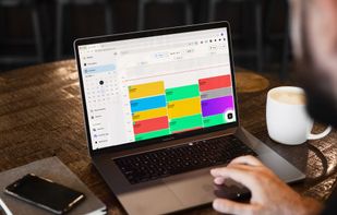 Customer managing appointments using Booklux booking software on a laptop in a café.
