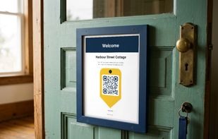 The Keegix QR sign on a cottage door: every code sits inside the yellow key tag, on every plan.