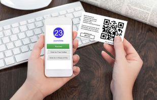 Employee using mobile device to punch card.