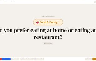 Topic Discussion mode — A Food & Eating discussion question displayed full-screen with topic selector, "Show vocabulary" button, and the bottom toolbar with navigation, reshuffle, and random student/pair picker.