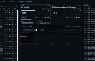 The whole station on one screen: two decks, the queue the AI editor built, cart wall and a live mic, with the AI DJ on.